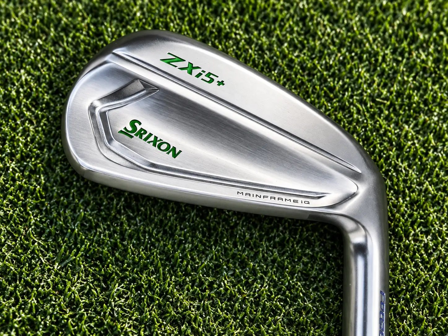 Close-up of the back cavity of a Srixon ZXi iron against a dark green background