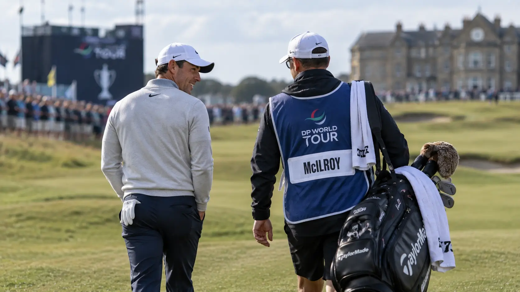 LPGA caddie reviewing yardage book beside a staff golf bag on the practice green