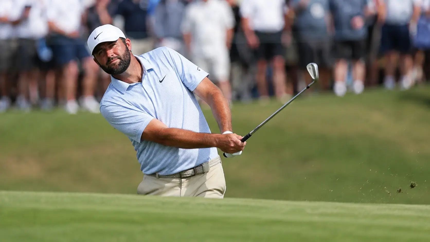 Scottie Scheffler hitting an iron approach shot during the 2026 BMW Championship at Bellerive Country Club.